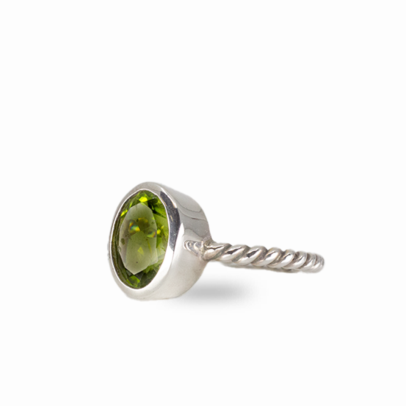 Oval peridot gemstone ring in sterling silver with vivid green color and minimalist stacking design