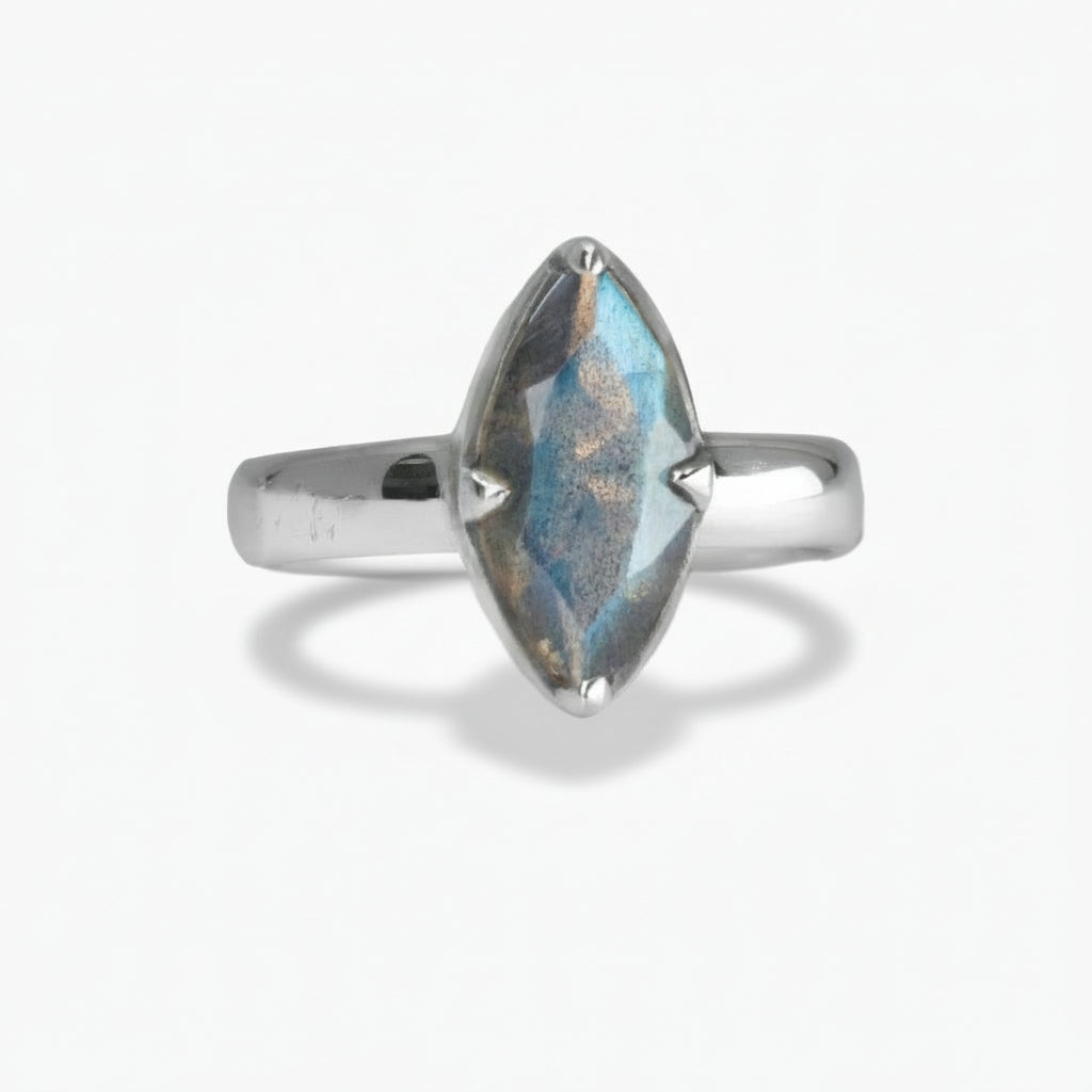 Marquise-cut faceted Labradorite ring with blue iridescent flashes set in polished sterling silver on a white background. | MADE IN EARTH