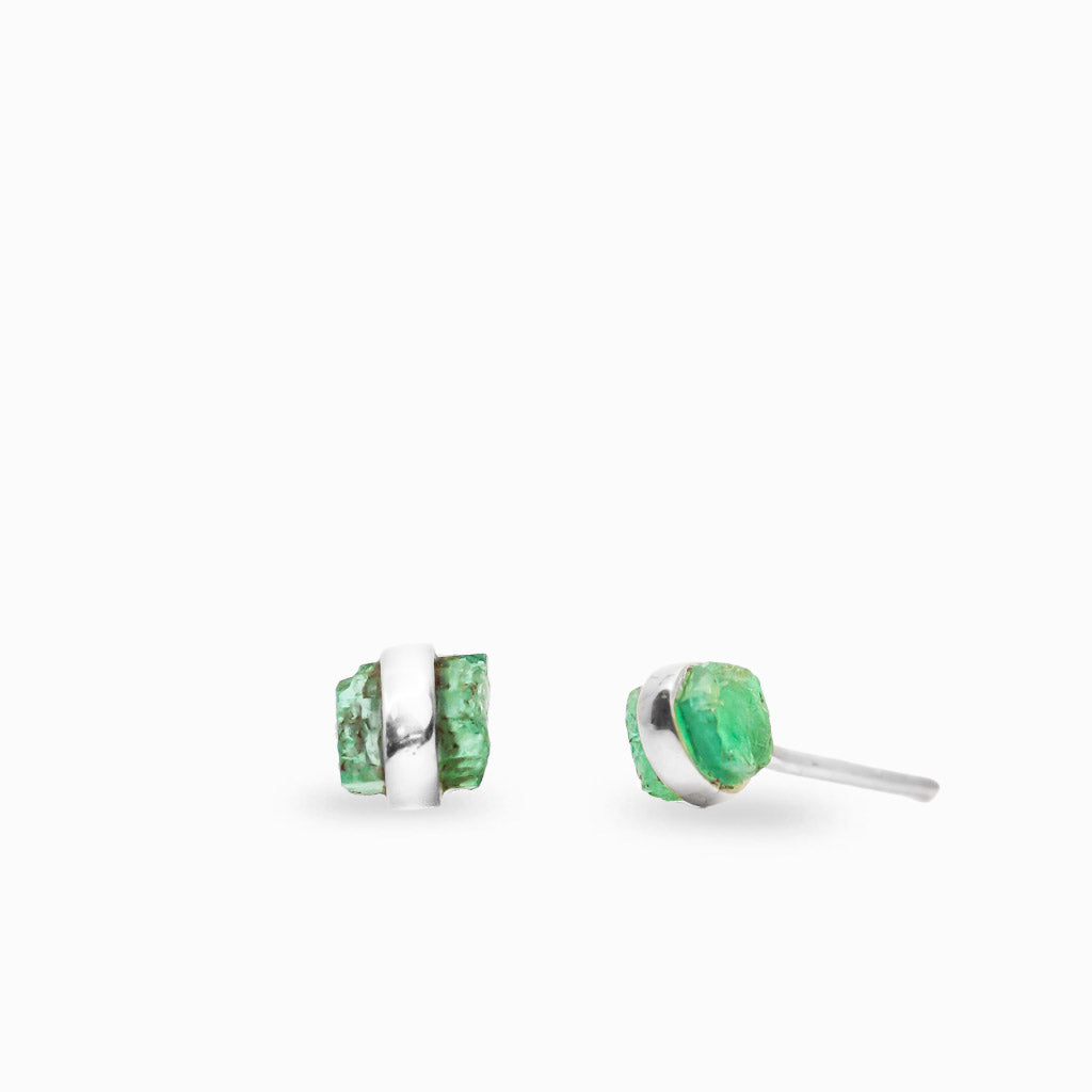 Raw green Emerald crystal stud earrings wrapped with polished 925 sterling silver bands, showcasing natural texture and form.