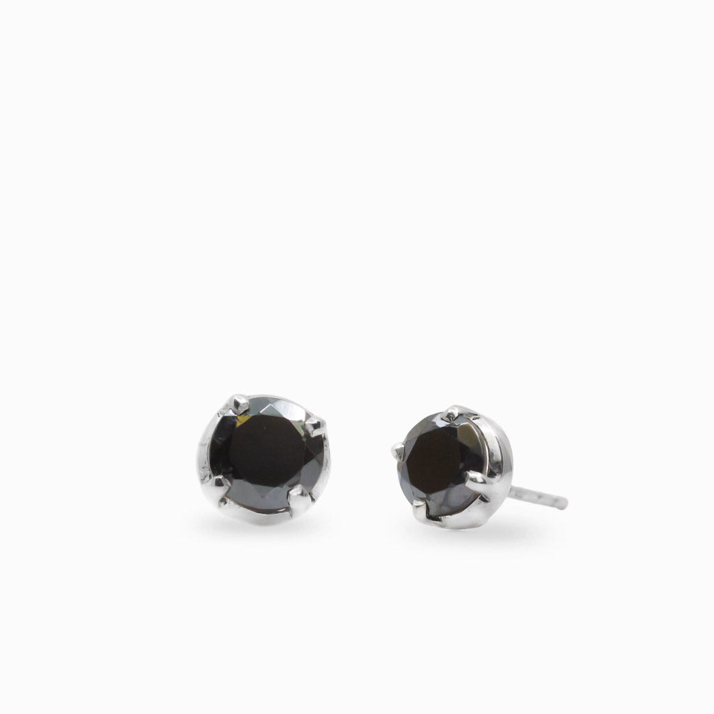 Round faceted Black Hematite stud earrings in polished 925 sterling silver prong settings with a dark reflective metallic finish.