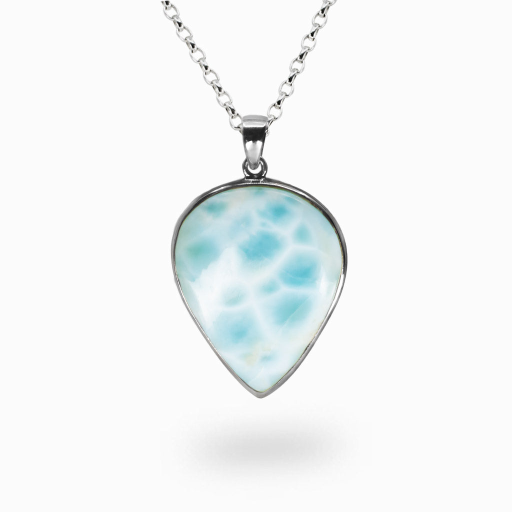 Teardrop Larimar pendant with soft blue and white wave-like patterns set in sterling silver on a chain. | MADE IN EARTH
