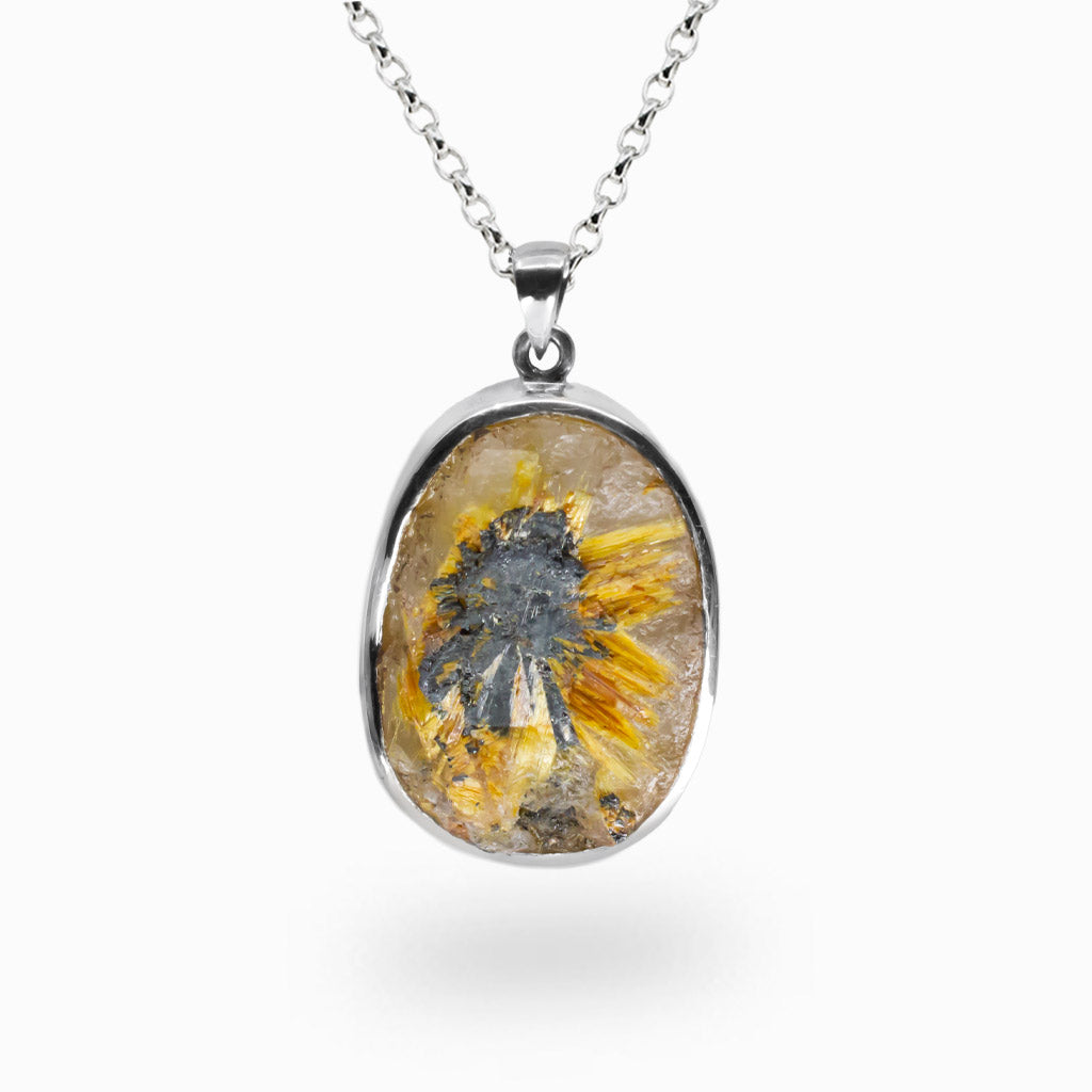 Raw rutilated quartz pendant with golden rutile bursts and dark hematite core, set in sterling silver on a chain.
