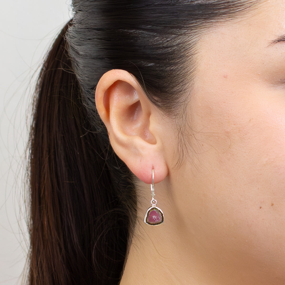 Watermelon tourmaline slice earrings with green borders and pink centers set in sterling silver lever-back hooks. | MADE IN EARTH