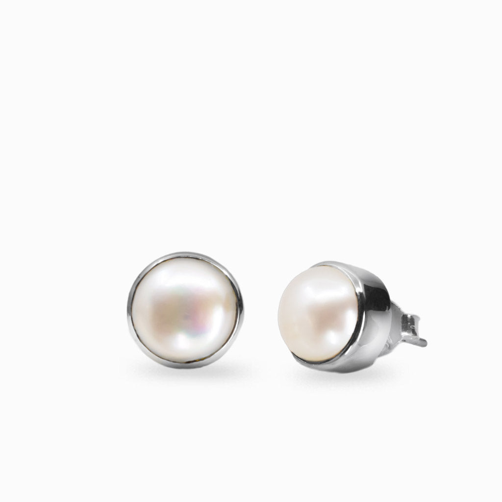 Pair of pearl stud earrings on a white background | MADE IN EARTH