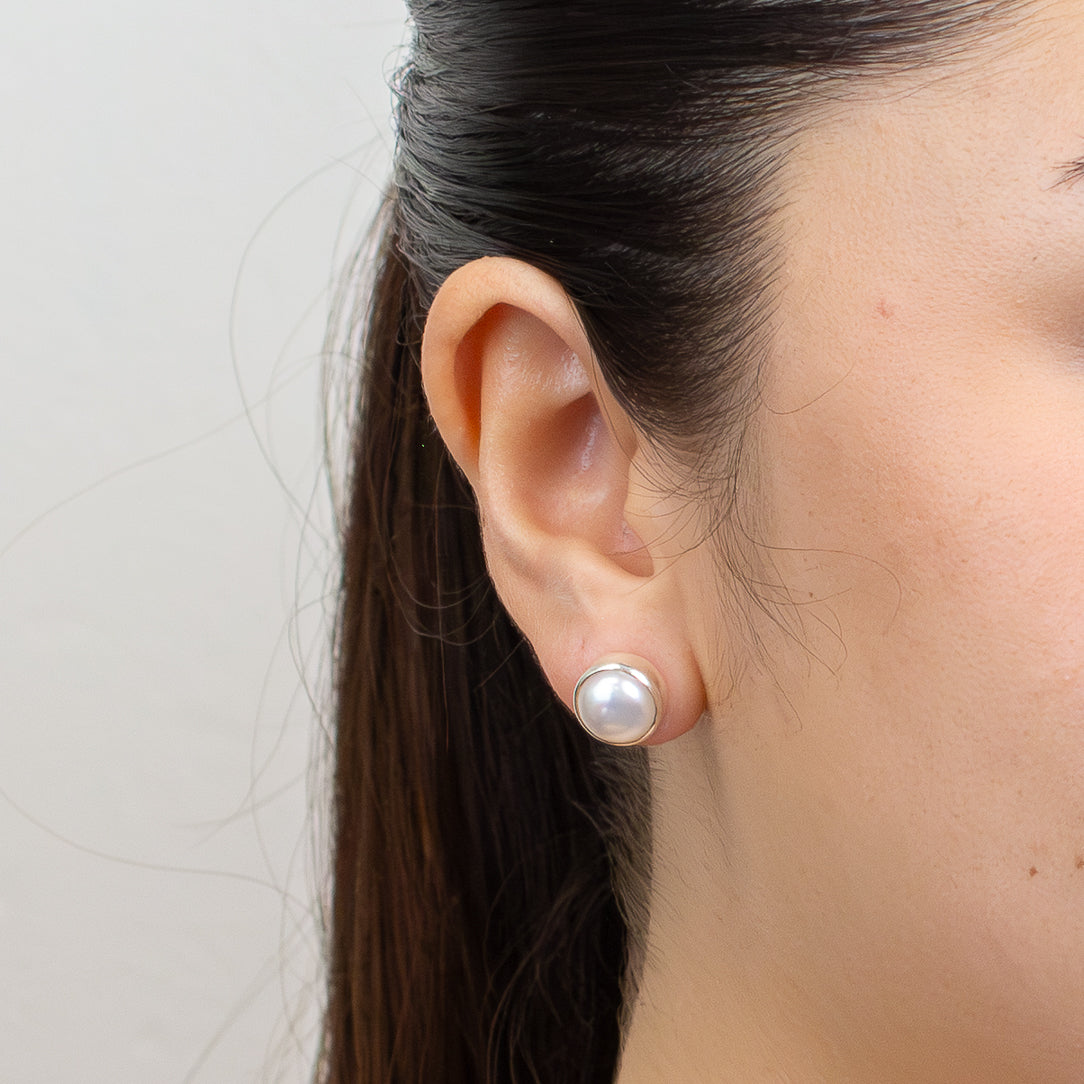 Pair of pearl stud earrings on a white background | MADE IN EARTH