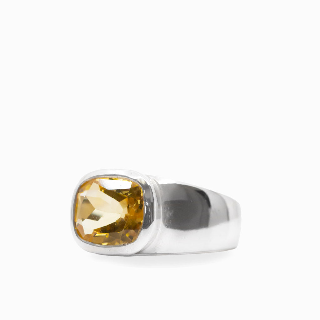 Cushion-shaped faceted golden Citrine gemstone set in a polished 925 sterling silver ring.