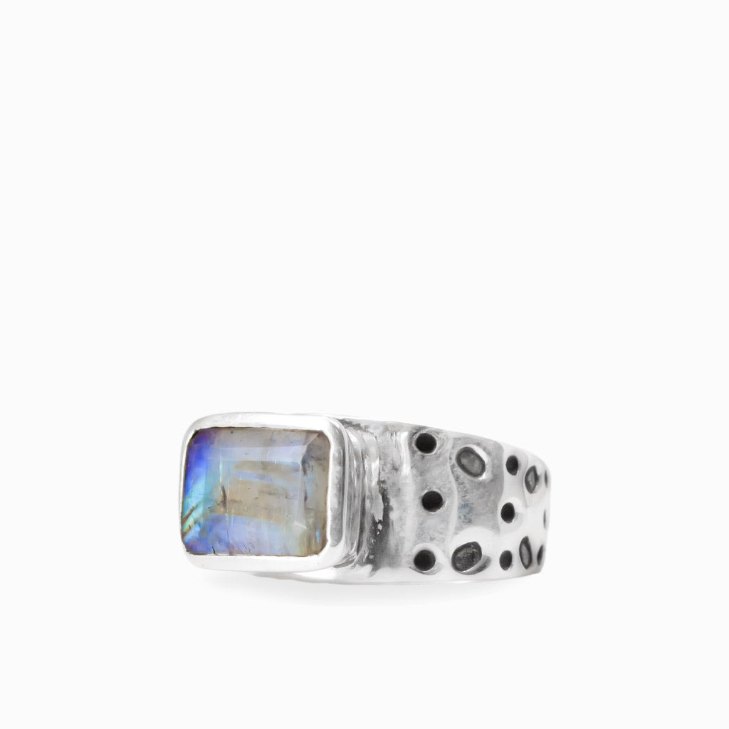 Rectangular Rainbow Moonstone cabochon with subtle iridescent flashes set in a textured 925 sterling silver ring.