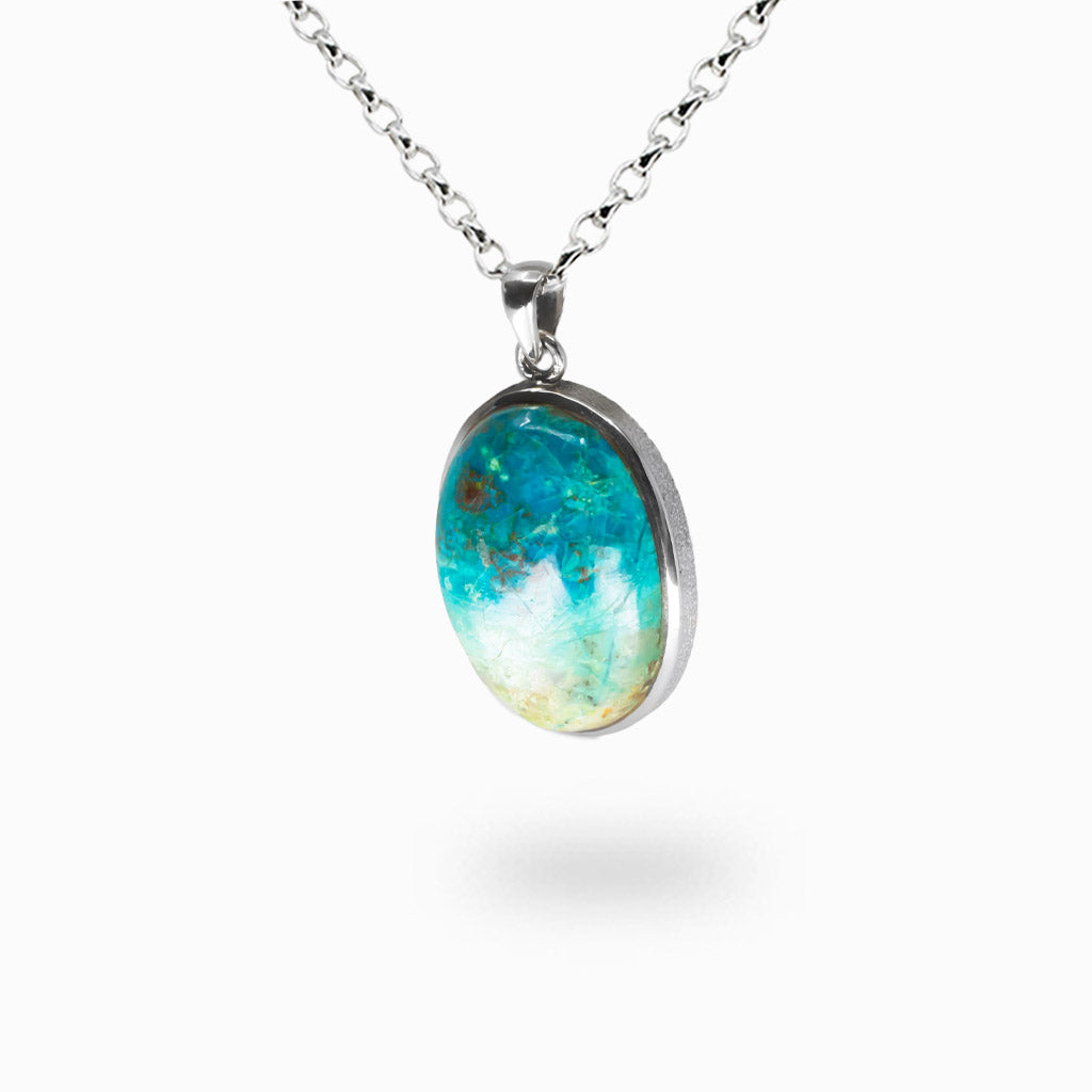 Oval Eilat Chrysocolla pendant necklace with blue-green and copper marbling, polished cabochon set in sterling silver bezel on silver chain. | MADE IN EARTH
