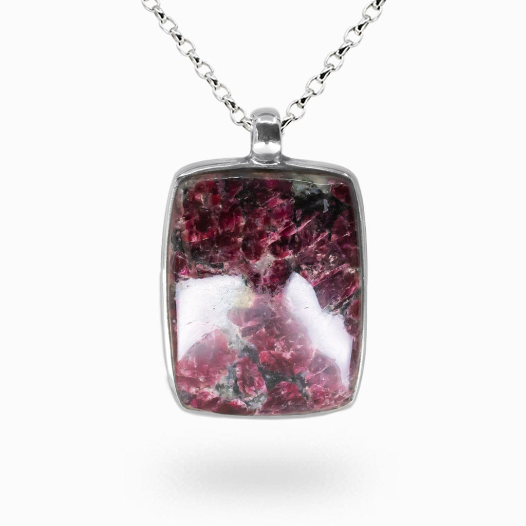 Eudialyte rectangle cabochon necklace in sterling silver bezel with deep maroon crystal patterns and polished natural stone surface.|MADE IN EARTH