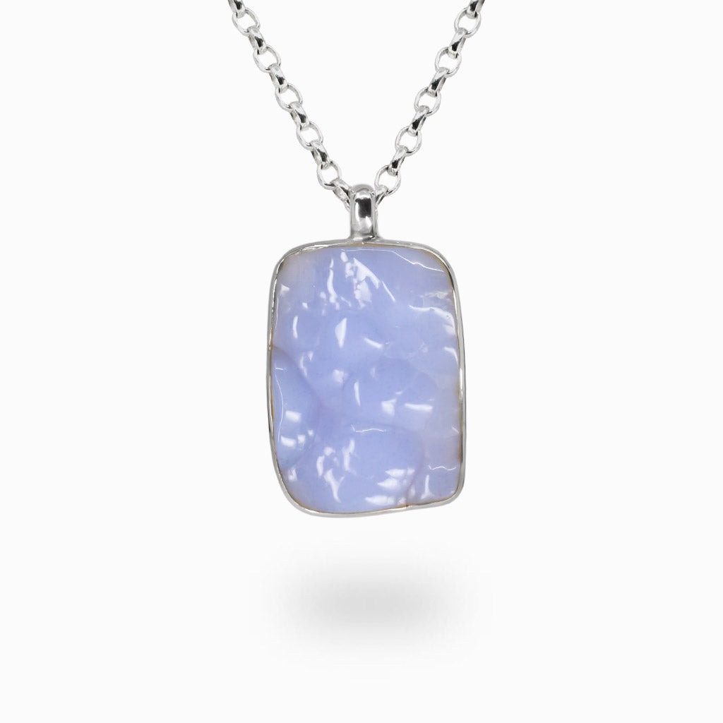 Blue botryoidal chalcedony rectangle cabochon necklace in sterling silver bezel with soft cloud-like blue patterns and natural gemstone texture.| MADE IN EARTH                                                                             