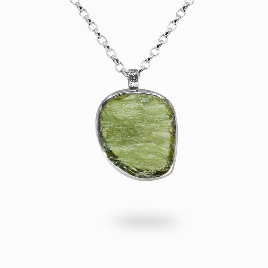 Rare raw Moldavite necklace set in sterling silver. A powerful meteorite stone known for transformation, clarity, and spiritual growth. | MADE IN EARTH