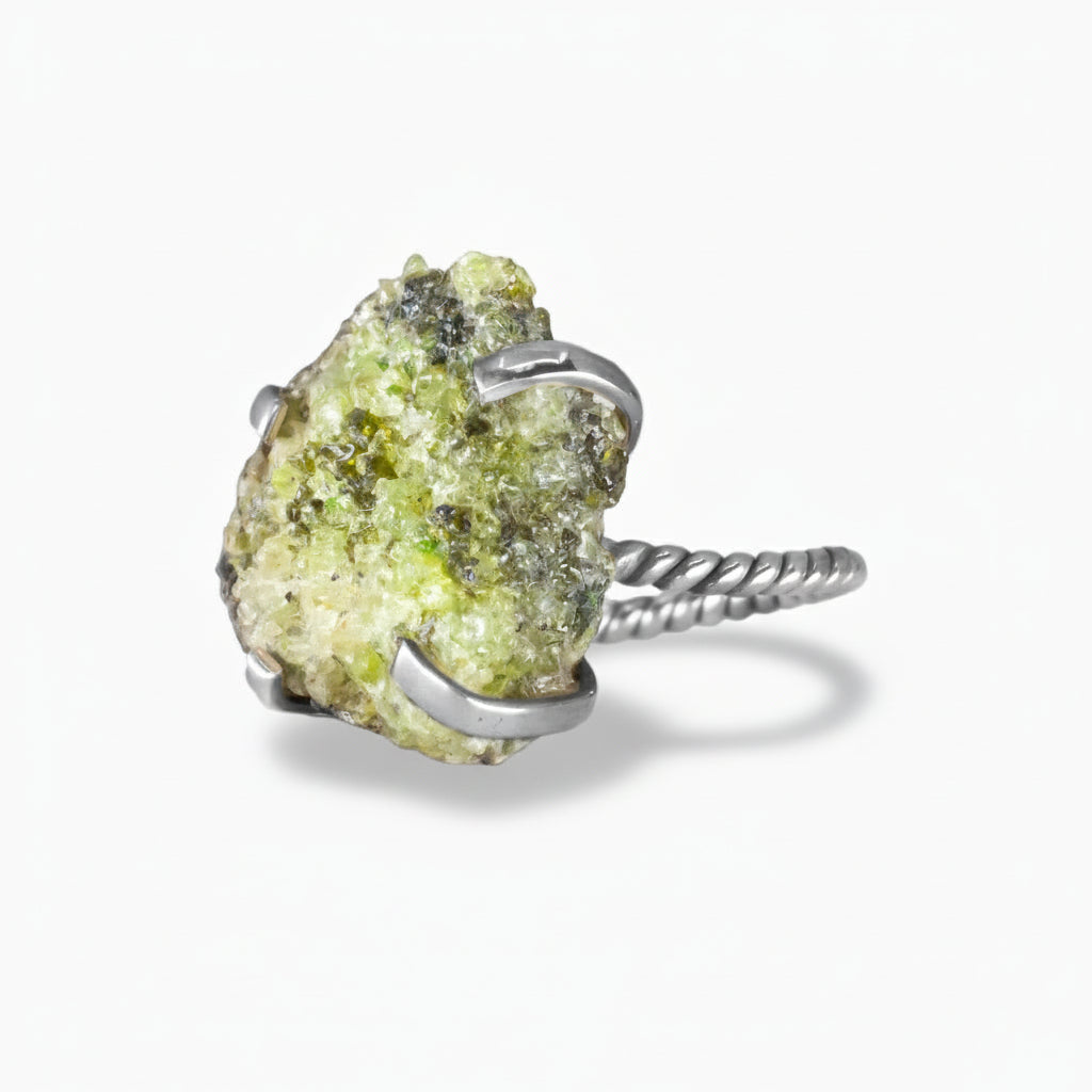 Raw green Peridot druzy crystal ring with silver prong setting and twisted sterling silver band on a white background. | MADE IN EARTH