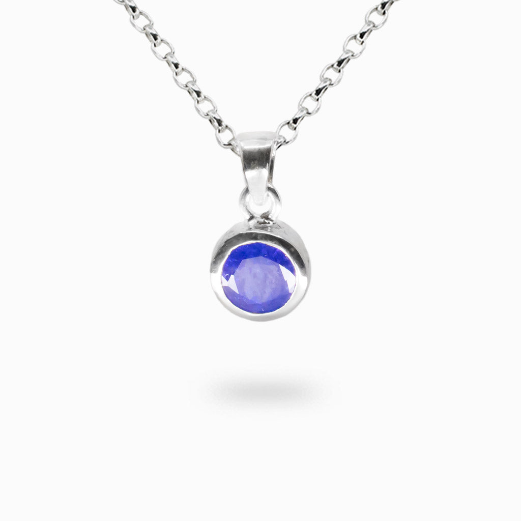 Faceted round tanzanite gemstone pendant set in sterling silver bezel.