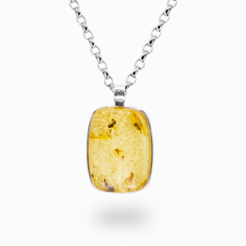 Rectangular Amber cabochon pendant necklace in sterling silver featuring warm golden honey-colored fossilized resin.