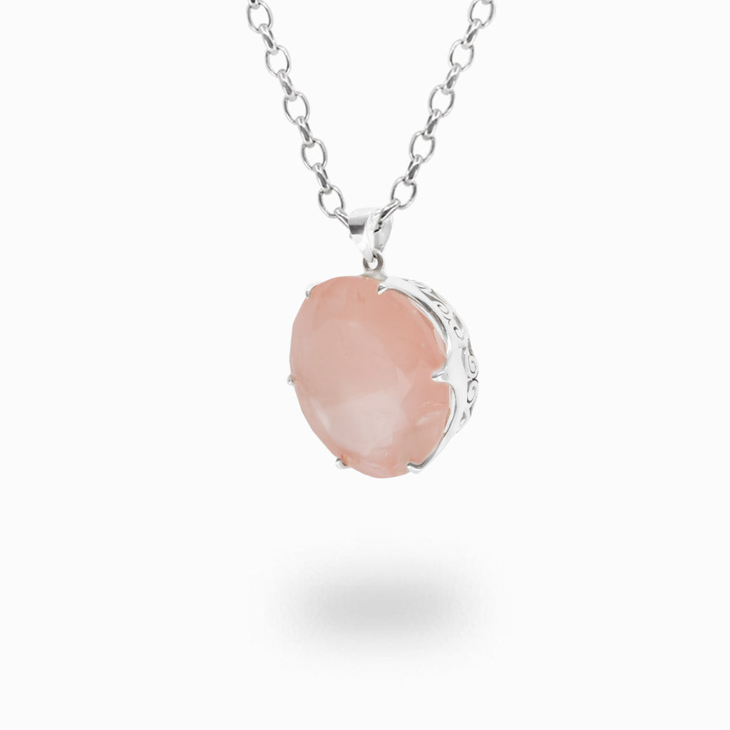 Faceted Rose Quartz pendant necklace in sterling silver featuring a soft translucent pink gemstone.