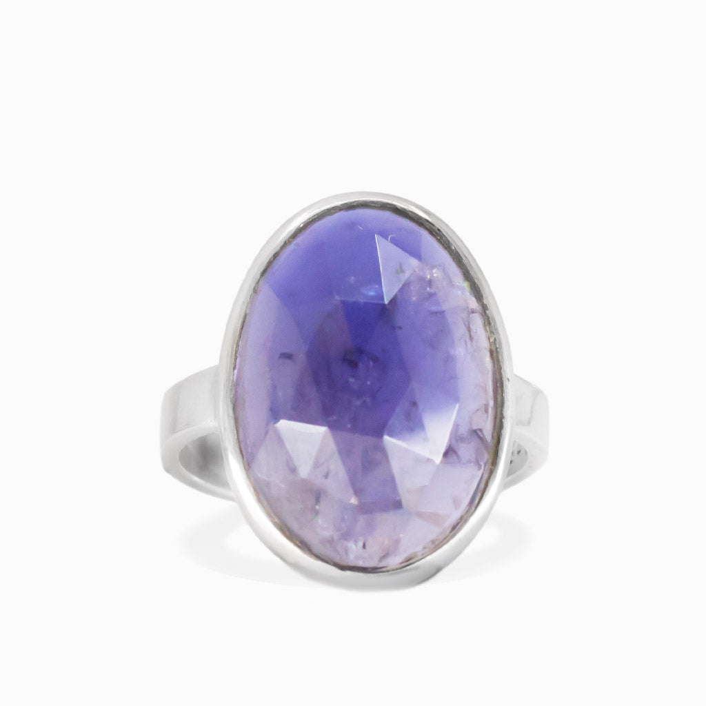 Faceted iolite oval ring in sterling silver with deep blue violet gemstone and polished finish