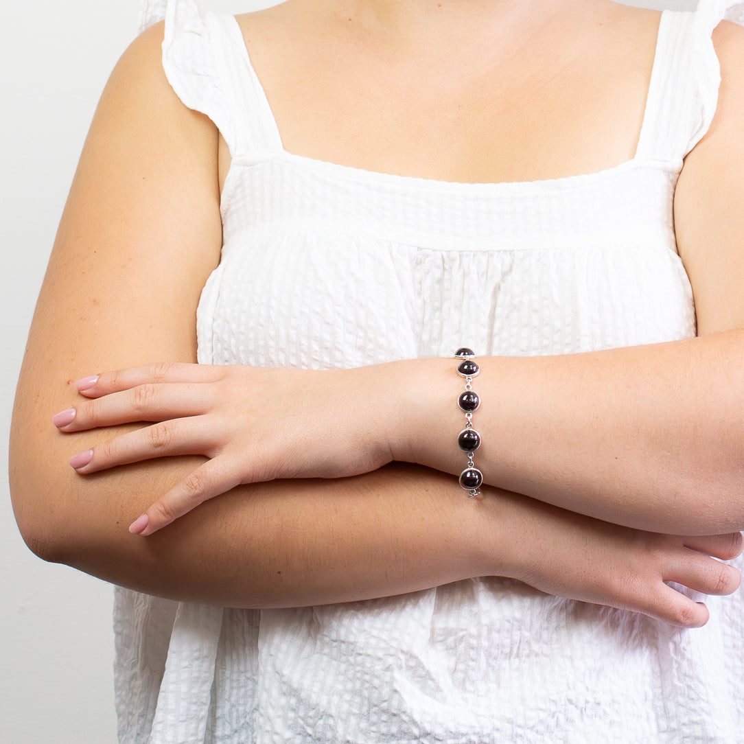 Sterling silver Garnet bracelet featuring faceted deep red gemstones with elegant sparkle and timeless design.