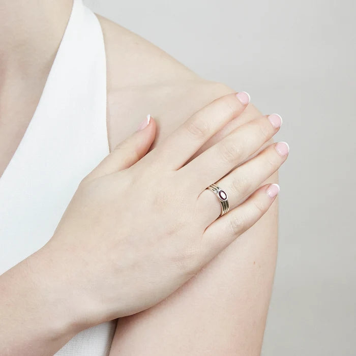 Oval Ruby gemstone bezel set in textured sterling silver triple-band ring.