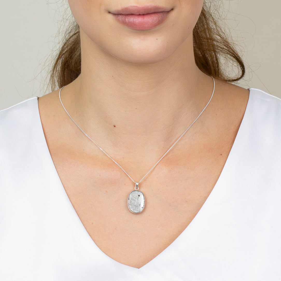 Raw oval Gibeon meteorite necklace in sterling silver