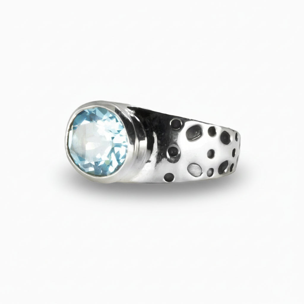 Oval Blue Topaz ring in sterling silver featuring vibrant electric-blue gemstone.