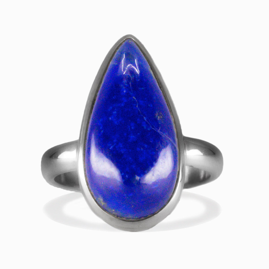 Tear shaped lapis lazuli cabochon ring set in sterling silver with deep blue gemstone and pyrite flecks. MADE IN EARTH