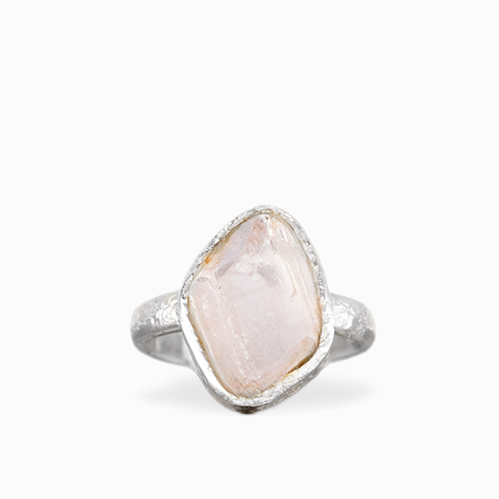 Freeform Rose Quartz ring with pale blush-pink gemstone, natural striations, textured sterling silver bezel, and matching band.