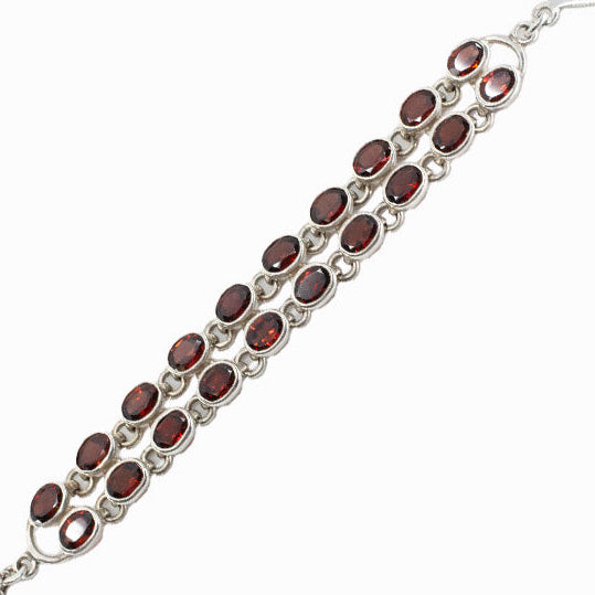 Faceted Garnet gemstone bracelet in sterling silver with deep red oval stones.