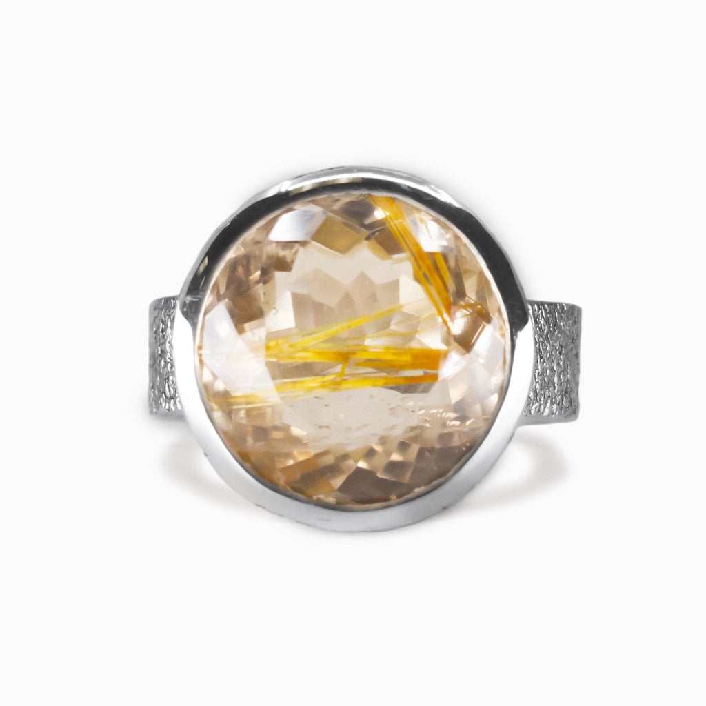 Faceted round golden rutilated quartz ring set in sterling silver bezel with golden rutile inclusions