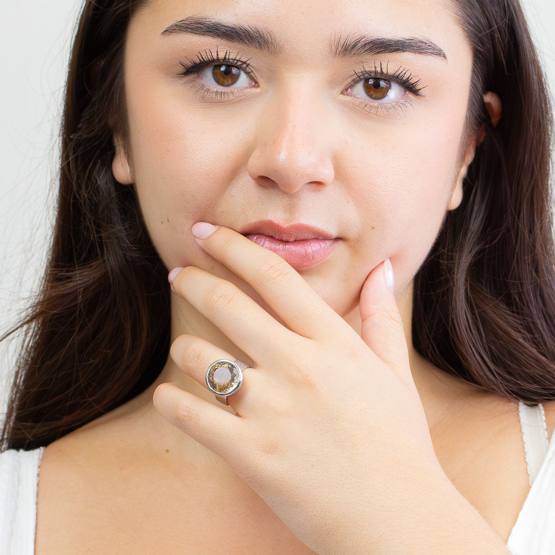 Faceted round golden rutilated quartz ring set in sterling silver bezel with golden rutile inclusions