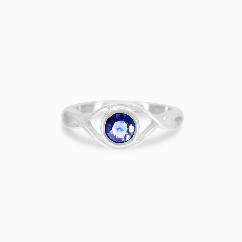 Round faceted deep blue Kyanite gemstone in polished sterling silver eye design ring.