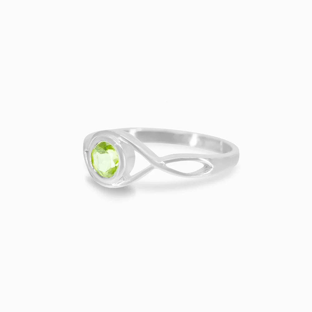 Round faceted green Peridot gemstone in polished sterling silver eye design ring.