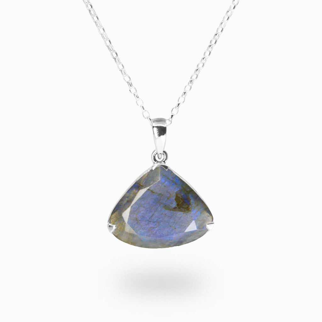 Trillion-shaped labradorite pendant on a silver chain against a white background