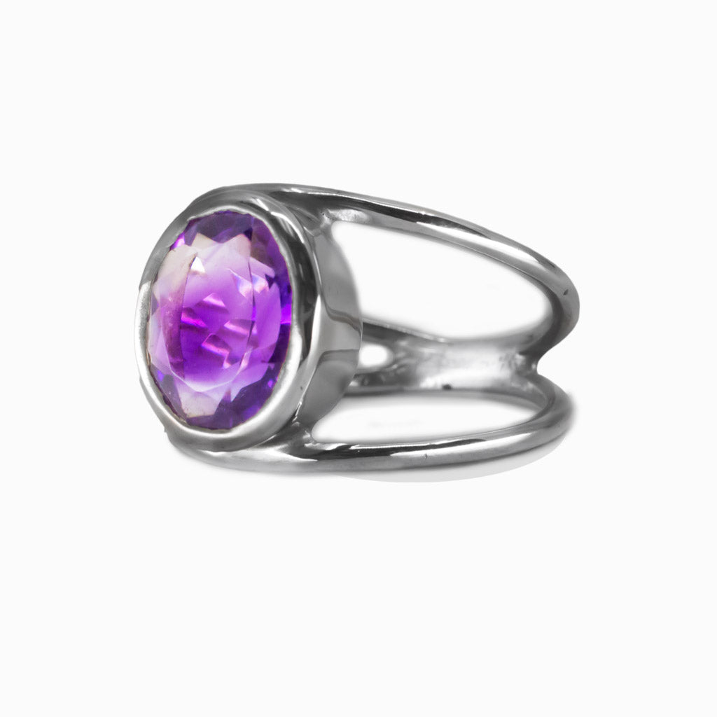 Faceted oval amethyst ring set in sterling silver with purple quartz gemstone. MADE IN EARTH