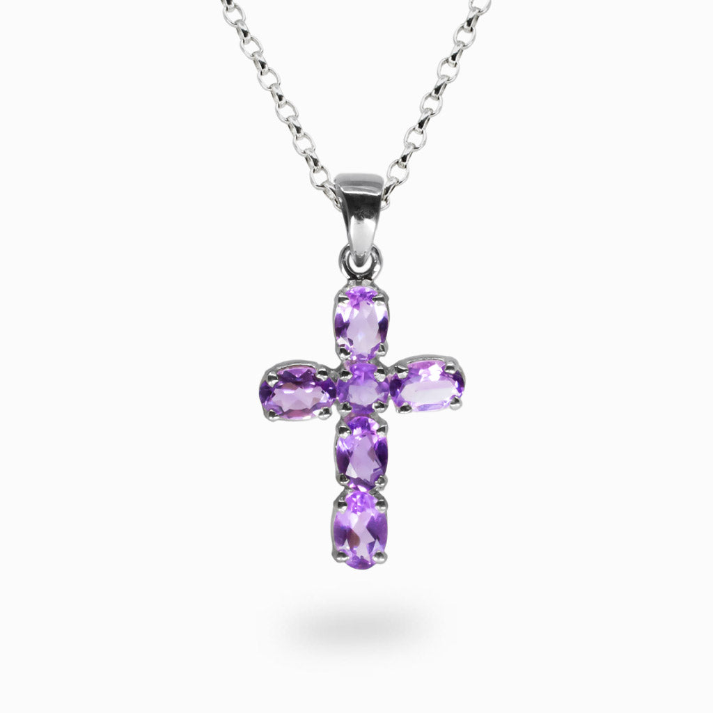 Faceted Amethyst cross pendant set in sterling silver on a chain. | MADE IN EARTH