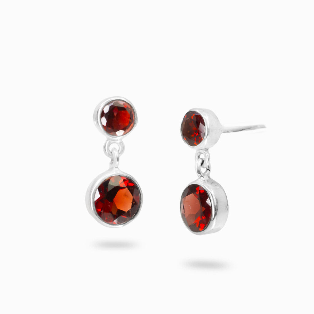 Double drop Garnet earrings in sterling silver featuring faceted deep red gemstones.