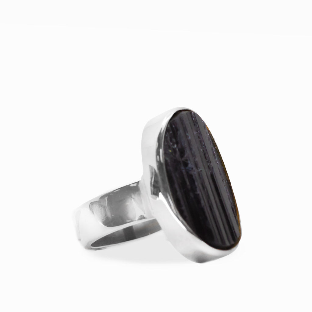 Large oval Black Tourmaline ring with natural vertical striations, polished sterling silver bezel setting, and wide band.