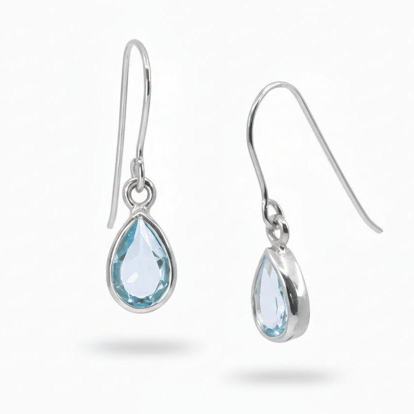 Teardrop faceted Blue Topaz gemstones bezel set in polished sterling silver drop earrings.