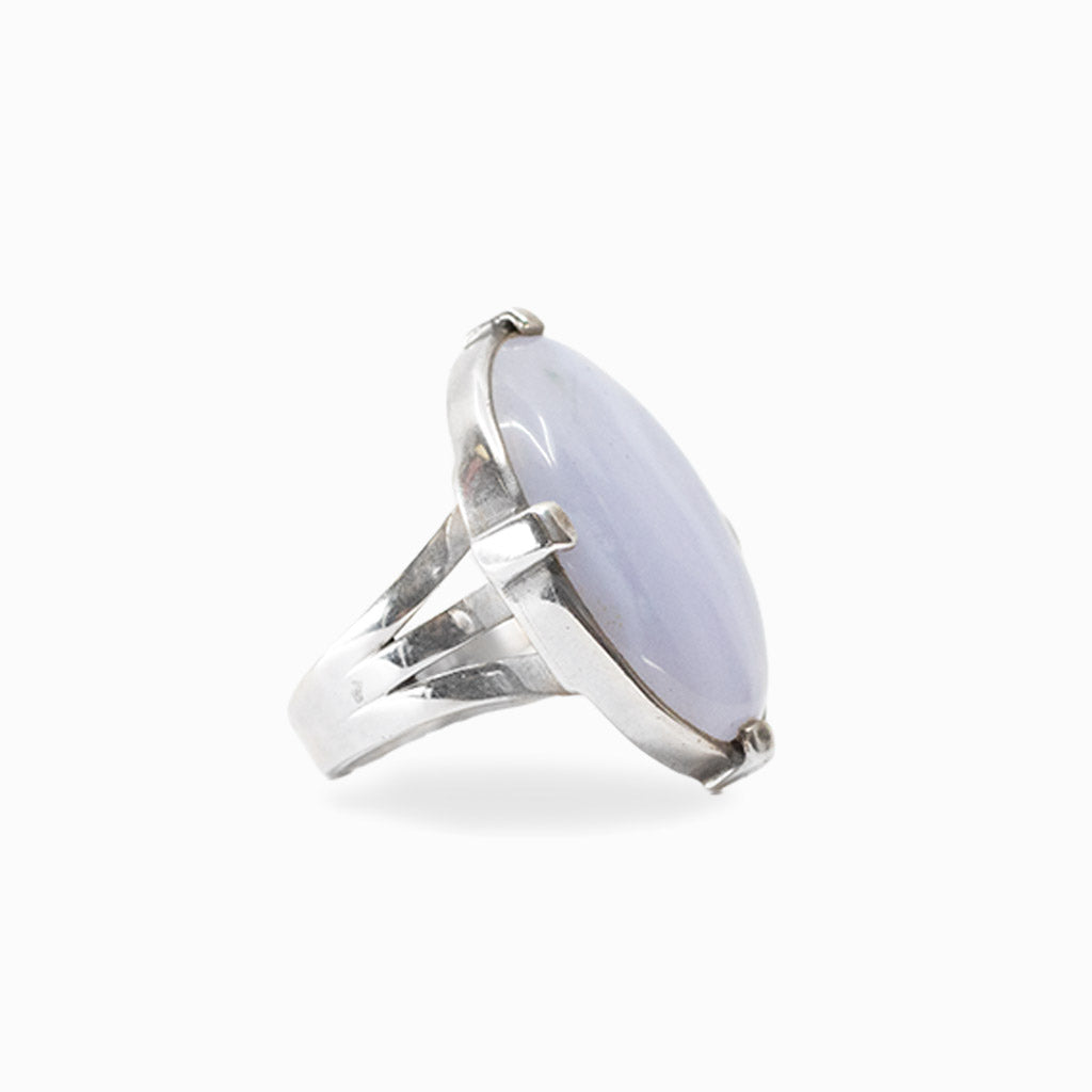 Oval pale blue Blue Lace Agate cabochon held by four prongs in a 925 sterling silver ring.