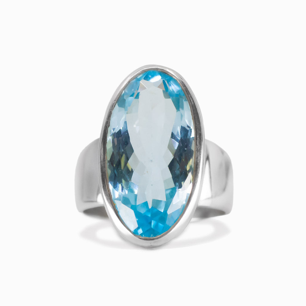 Faceted blue topaz oval ring in sterling silver with bright blue gemstone