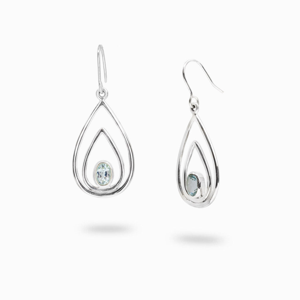 Sterling silver open teardrop earrings with faceted oval Blue Topaz gemstones.
