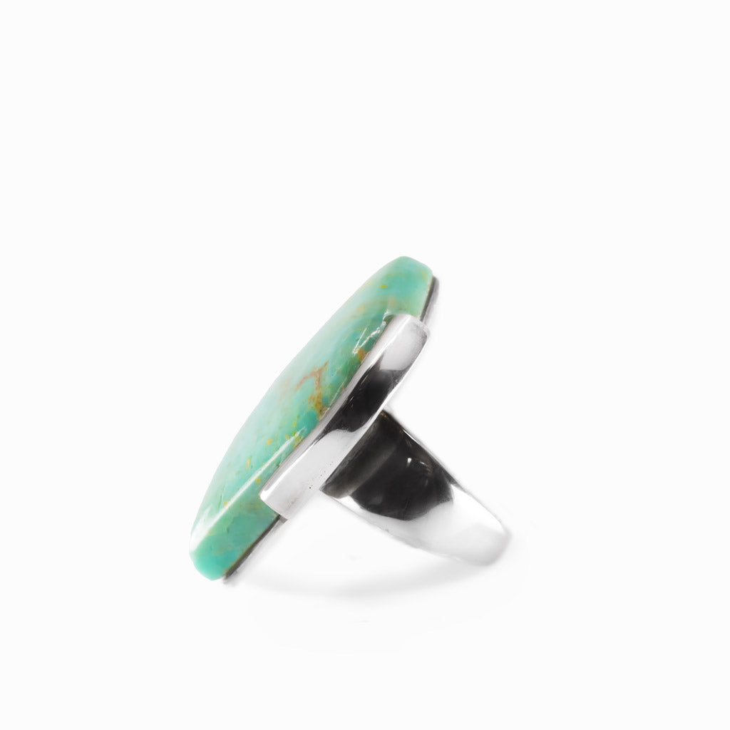 Campo Frio Turquoise freeform cabochon ring in polished sterling silver with aqua blue coloring and natural golden-brown matrix.