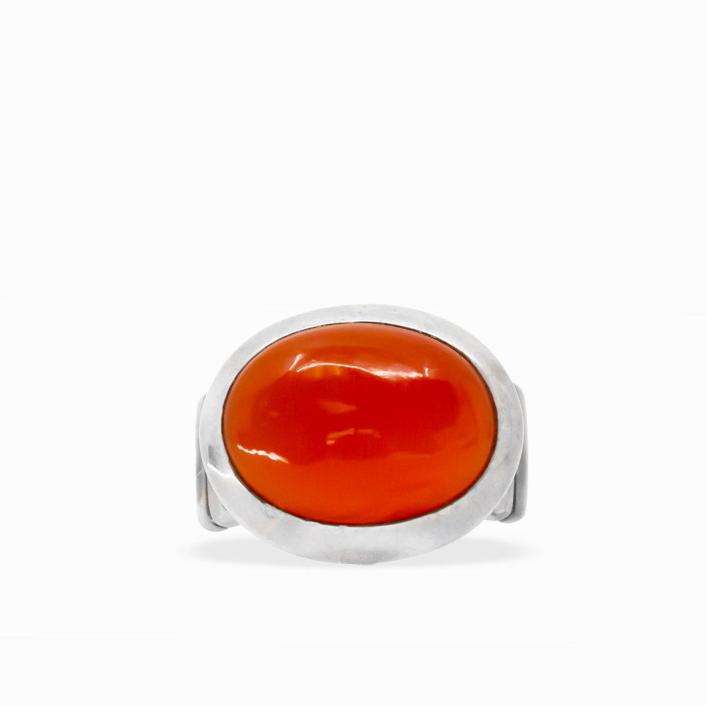 Bright orange-red oval Carnelian cabochon ring with smooth polished surface and wide sterling silver bezel setting.