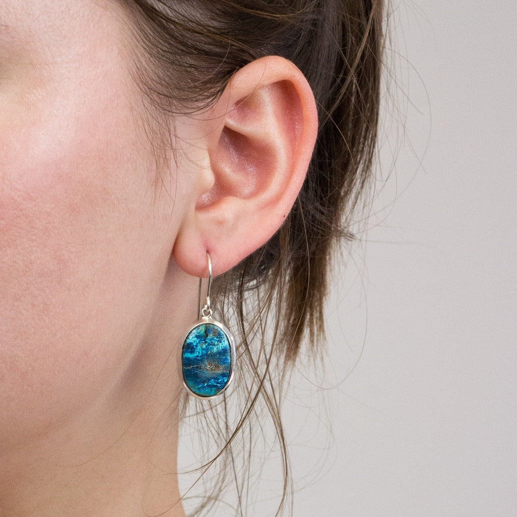 Shattuckite drop earrings on model