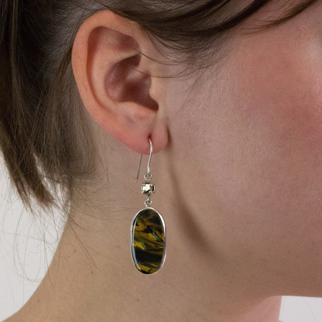 Pyrite and Pietersite drop earrings on model