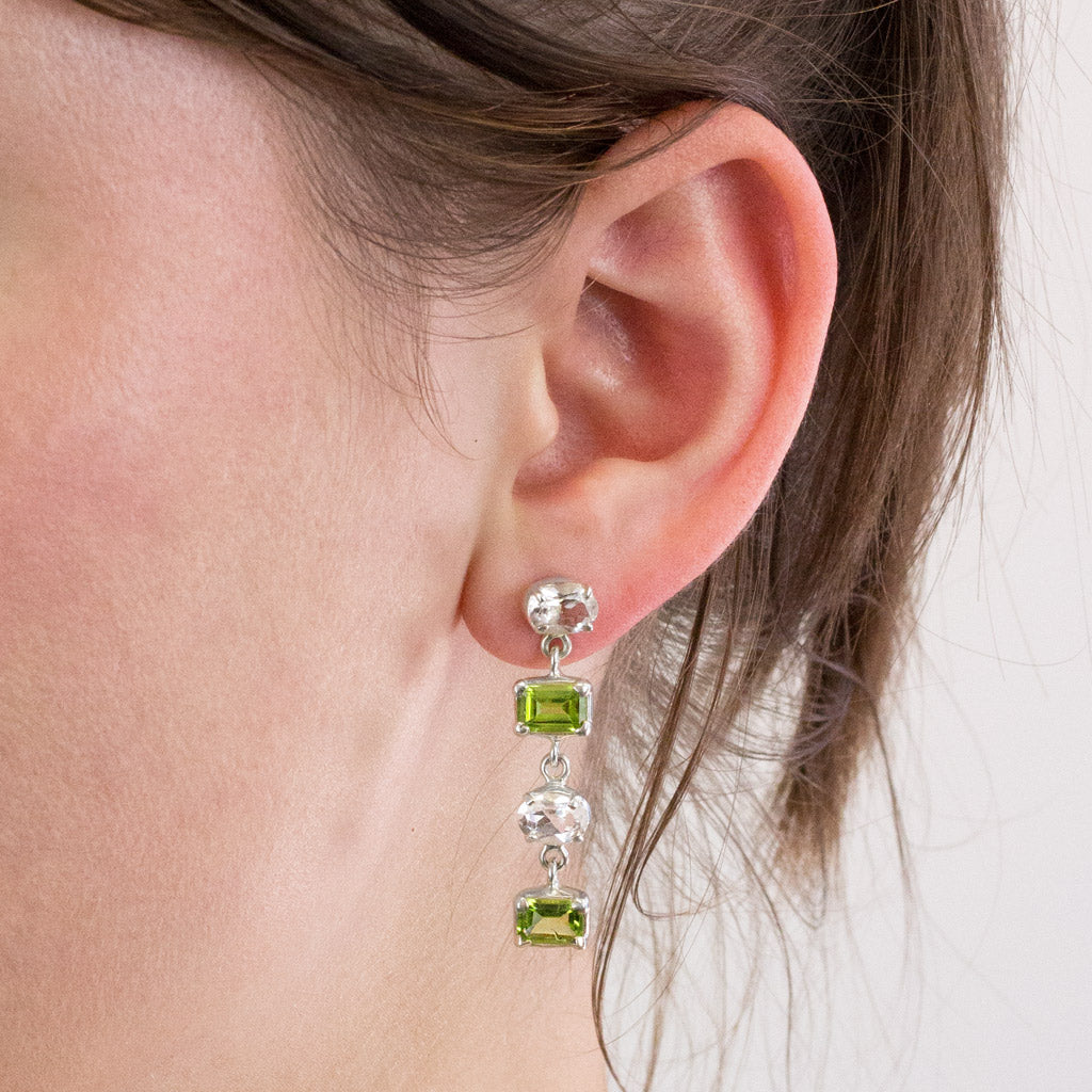 Peridot and Clear Quartz stud drop earrings on model