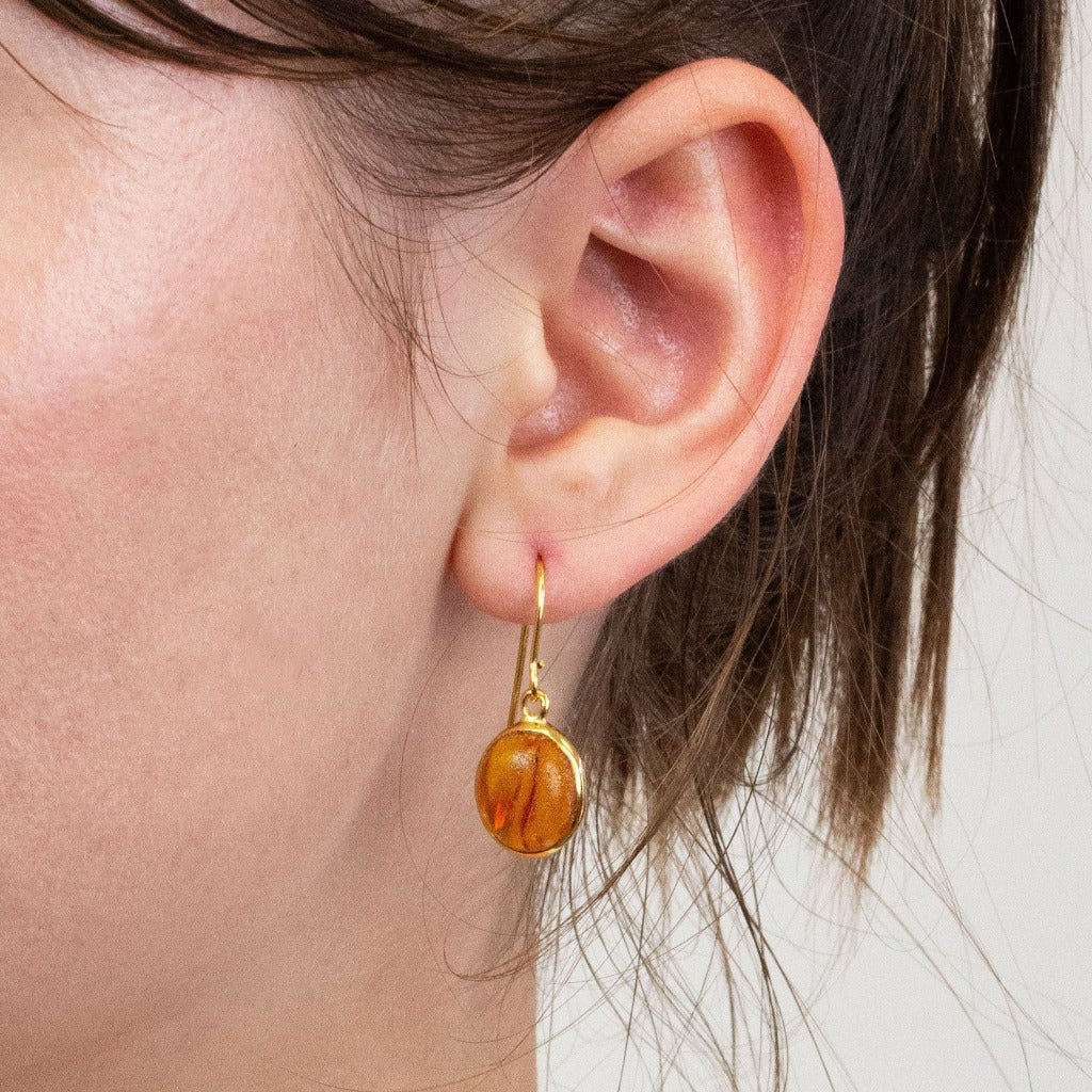 Amber drop earrings on model