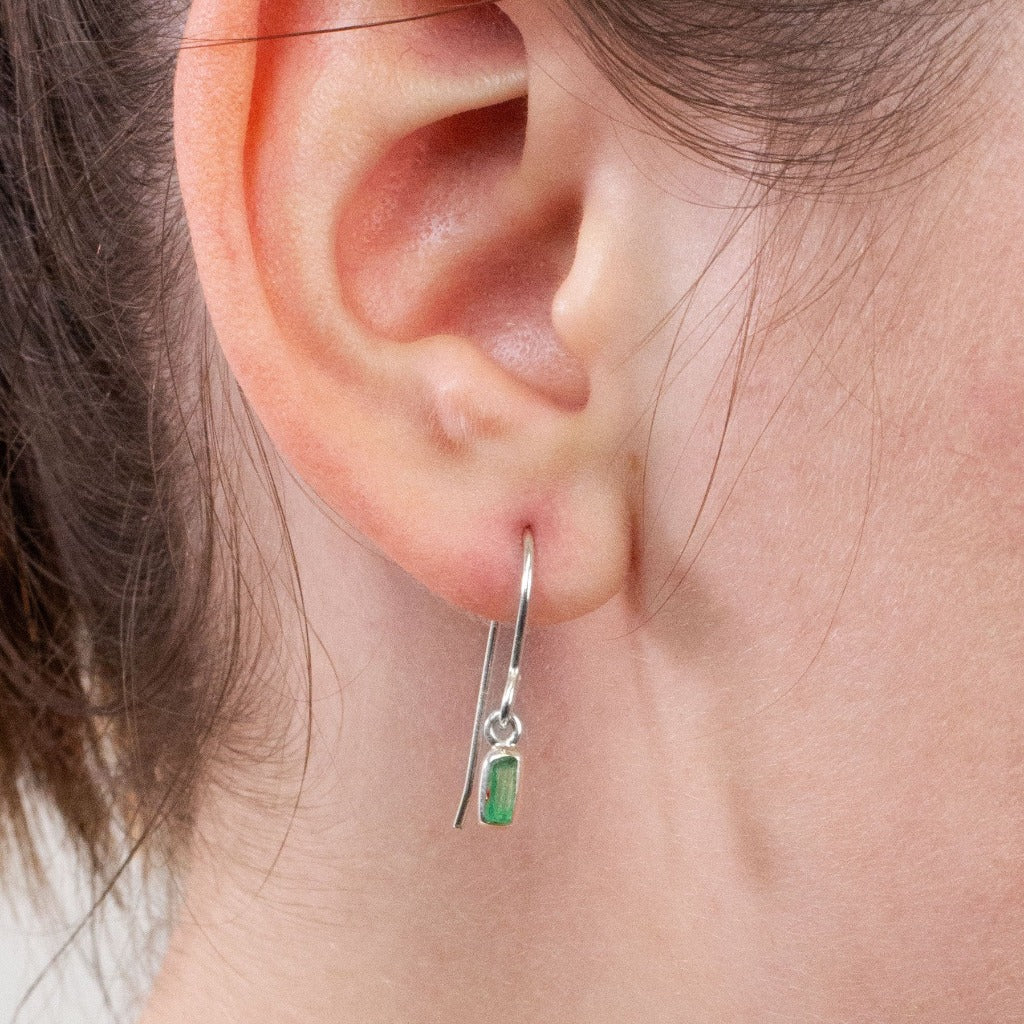 Emerald drop earrings on model