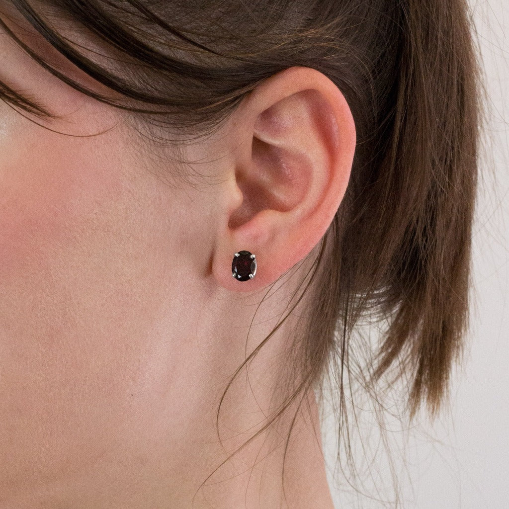 Garnet stud earrings on model