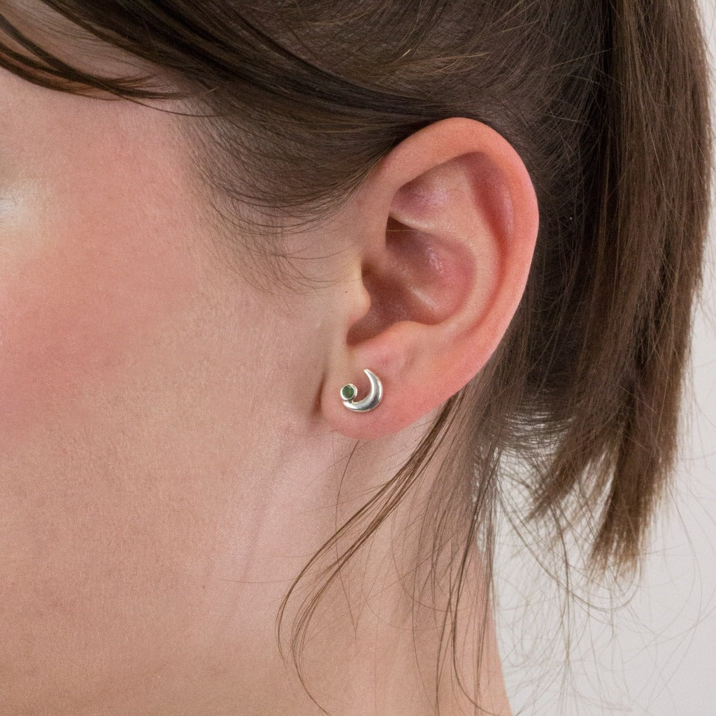 Emerald stud earrings on model