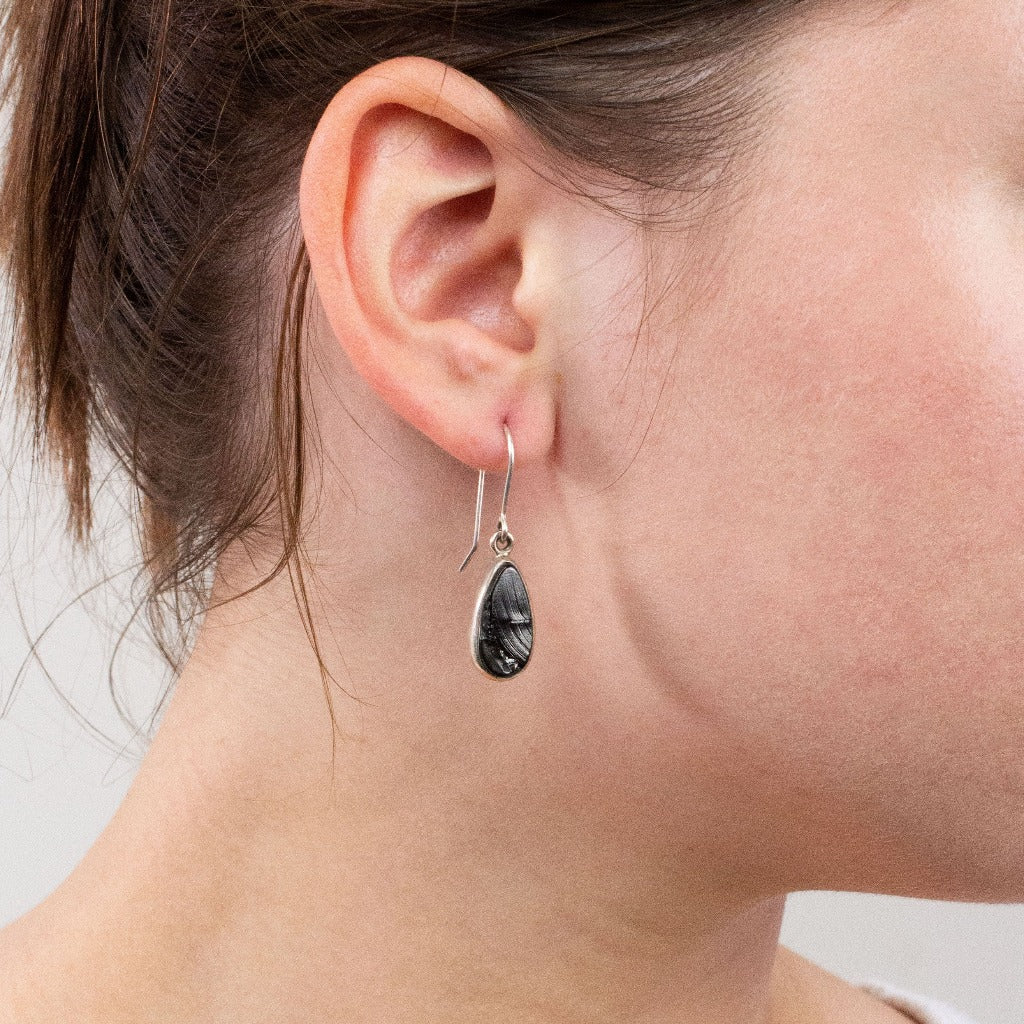 Shungite drop earrings on model